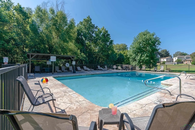 community pool featuring a patio area and fence