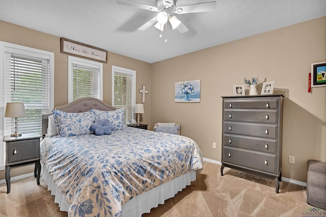 bedroom with carpet flooring, baseboards, and ceiling fan
