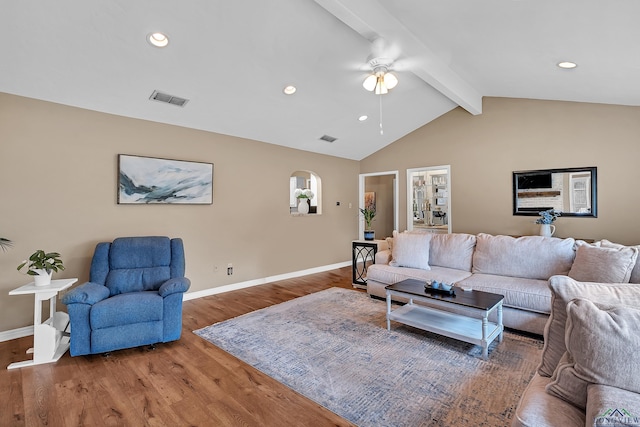 living area featuring a ceiling fan, baseboards, lofted ceiling with beams, and visible vents