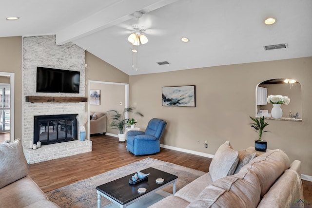 living area featuring visible vents, a ceiling fan, baseboards, and vaulted ceiling with beams