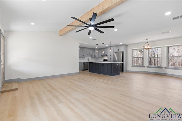 unfurnished living room featuring baseboards, visible vents, vaulted ceiling with beams, and light wood finished floors