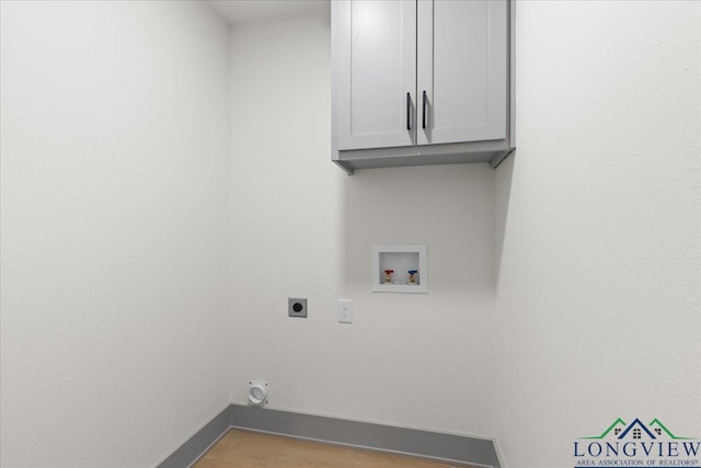 laundry area featuring cabinet space, hookup for a washing machine, baseboards, and electric dryer hookup