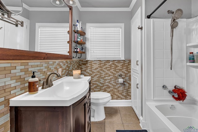 full bath with tile patterned flooring, toilet, vanity, tub / shower combination, and crown molding