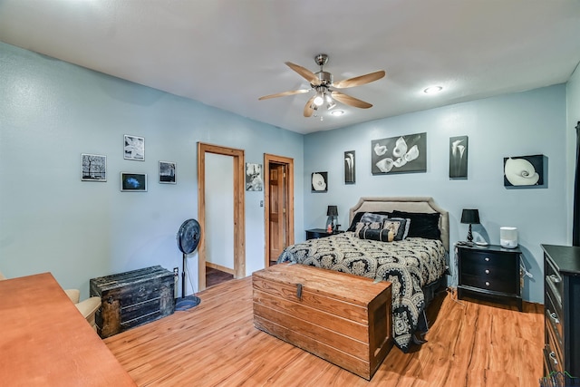 bedroom with light wood-type flooring and a ceiling fan