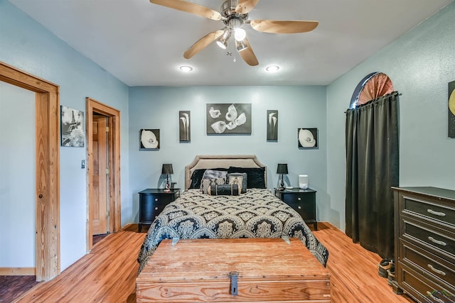 bedroom with a ceiling fan and light wood-type flooring