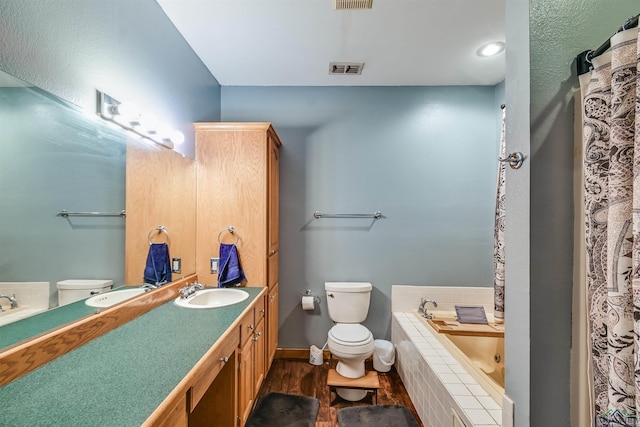 full bath featuring visible vents, a jetted tub, and toilet