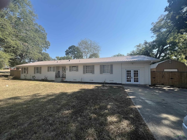 rear view of property featuring a yard and french doors