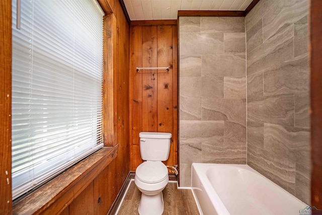 bathroom featuring wood finished floors, a washtub, toilet, and wood ceiling