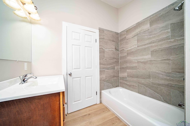 full bathroom featuring shower / bathtub combination, wood finished floors, and vanity