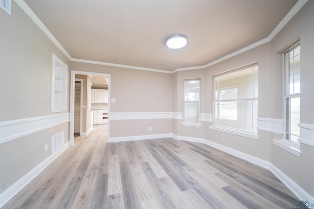 8686 Locust Rd, Big Sandy, TX 75755 - empty room with light wood finished floors, plenty of natural light, crown molding, and baseboards
