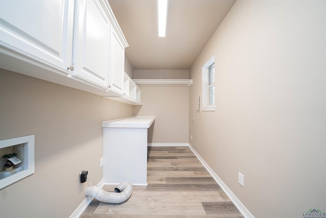 8686 Locust Rd, Big Sandy, TX 75755 - laundry room with cabinet space, light wood finished floors, hookup for a washing machine, and baseboards