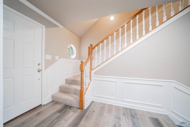 8686 Locust Rd, Big Sandy, TX 75755 - foyer entrance featuring a decorative wall, stairs, wood finished floors, and wainscoting