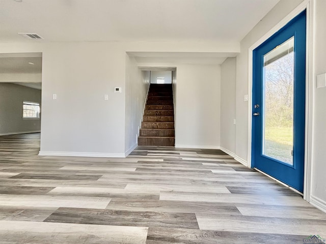 68 Eason Ln, Atlanta, TX 75551 - entryway with baseboards, visible vents, stairway, and wood finished floors