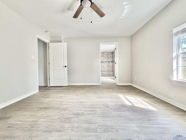 68 Eason Ln, Atlanta, TX 75551 - unfurnished bedroom featuring baseboards, ensuite bathroom, wood finished floors, and a ceiling fan