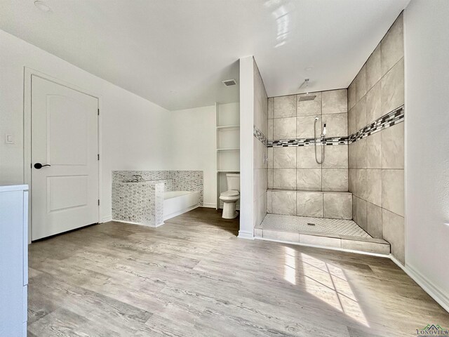 68 Eason Ln, Atlanta, TX 75551 - full bath featuring toilet, tiled shower, wood finished floors, a bath, and visible vents