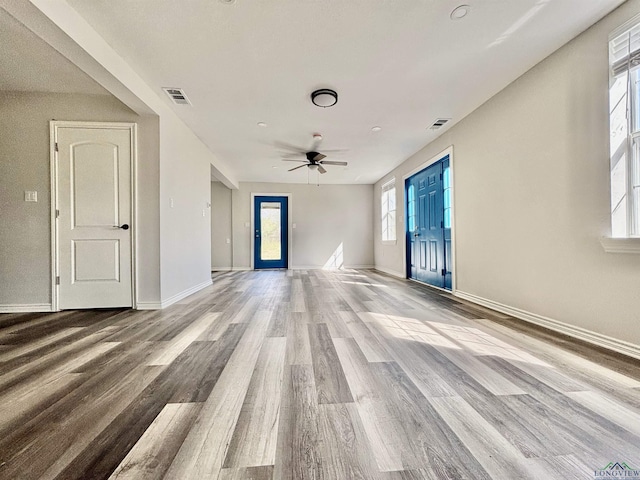 68 Eason Ln, Atlanta, TX 75551 - unfurnished living room with ceiling fan, visible vents, plenty of natural light, and wood finished floors