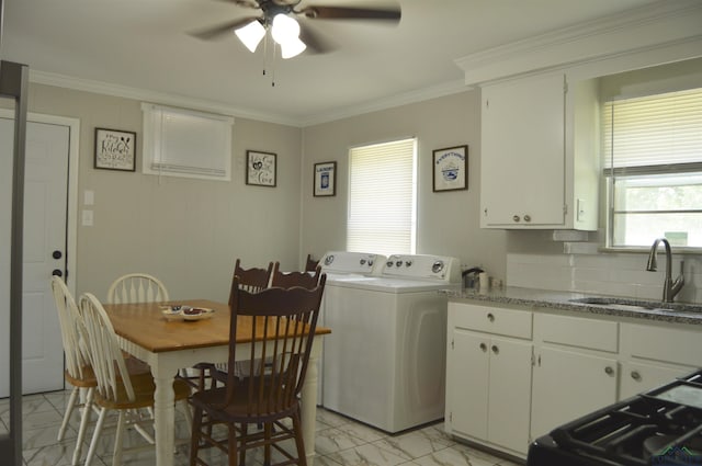 105 W Highland Ave, Longview, TX 75602 - kitchen with a sink, a ceiling fan, light marble finish floors, independent washer and dryer, and crown molding