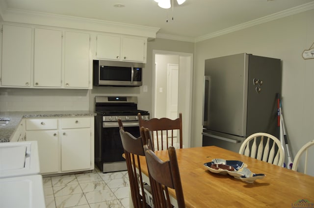 105 W Highland Ave, Longview, TX 75602 - kitchen featuring appliances with stainless steel finishes, light marble finish flooring, light countertops, white cabinets, and ornamental molding