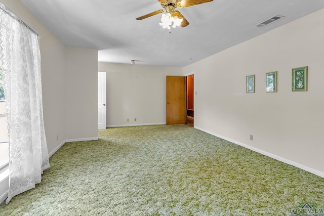unfurnished room with visible vents, baseboards, carpet flooring, and ceiling fan