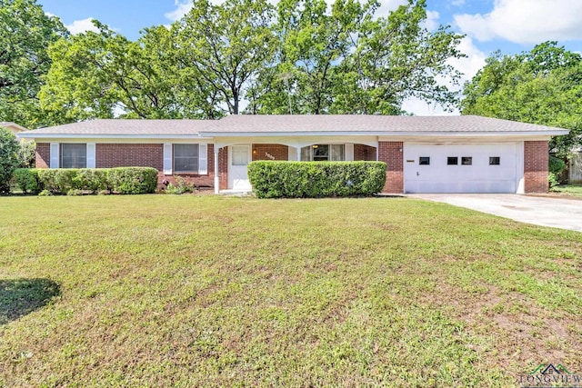 ranch-style home with brick siding, a front yard, a garage, and concrete driveway