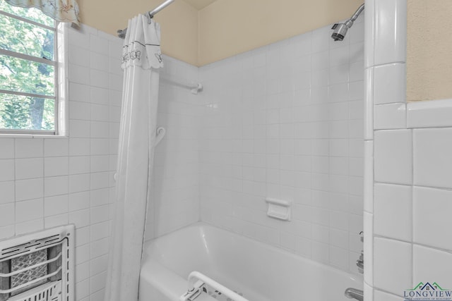 bathroom with shower / bath combo and heating unit
