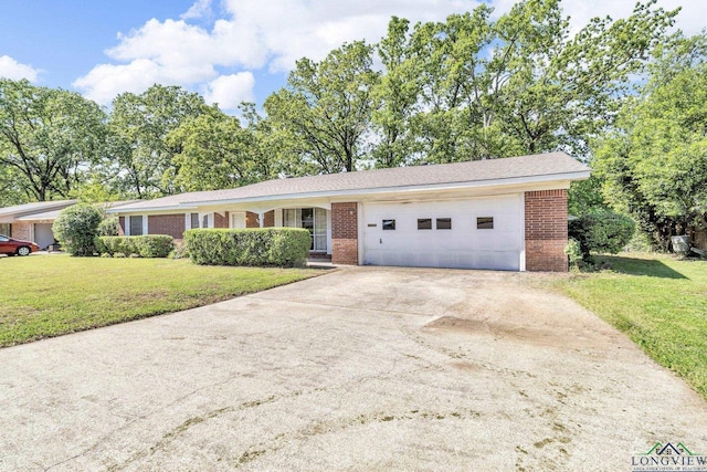 ranch-style house featuring concrete driveway, a front yard, brick siding, and a garage
