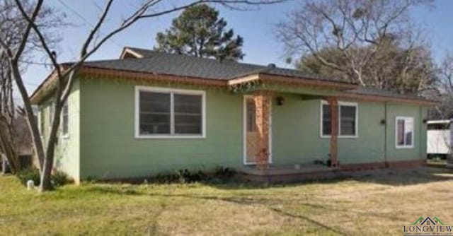 bungalow-style house with a front lawn