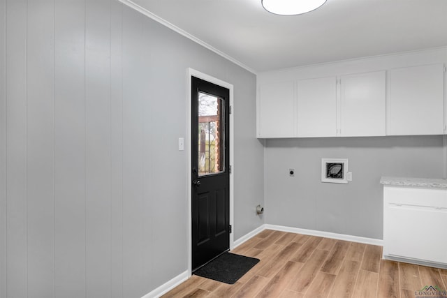 laundry room with hookup for a washing machine, cabinet space, ornamental molding, hookup for an electric dryer, and light wood-type flooring