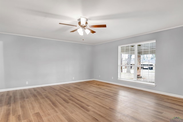 unfurnished room featuring a ceiling fan, baseboards, ornamental molding, and wood finished floors