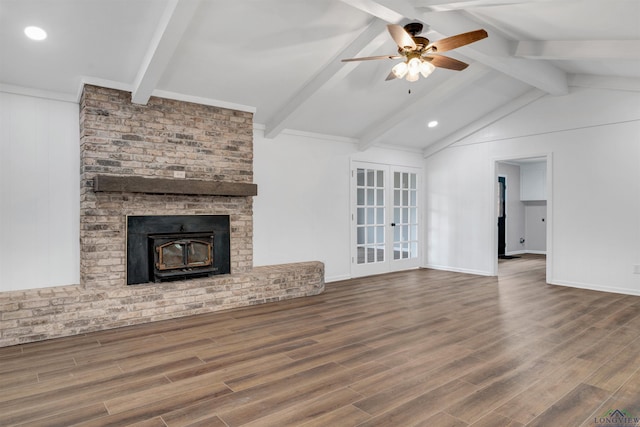 unfurnished living room featuring baseboards, lofted ceiling with beams, ceiling fan, wood finished floors, and french doors