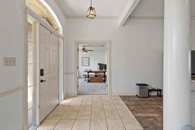 foyer featuring light tile patterned floors, ceiling fan, and crown molding