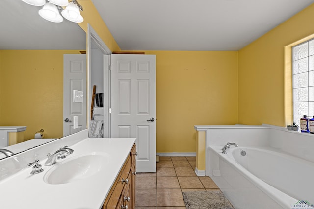 bathroom with tile patterned flooring, vanity, and a tub