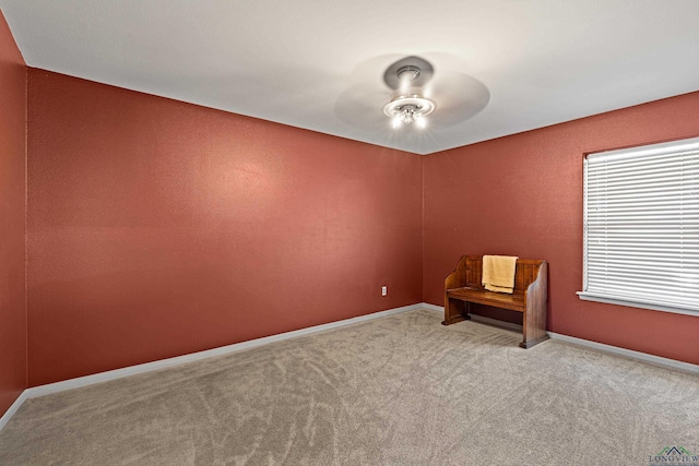 carpeted empty room featuring ceiling fan