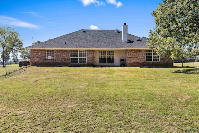 back of property featuring a lawn