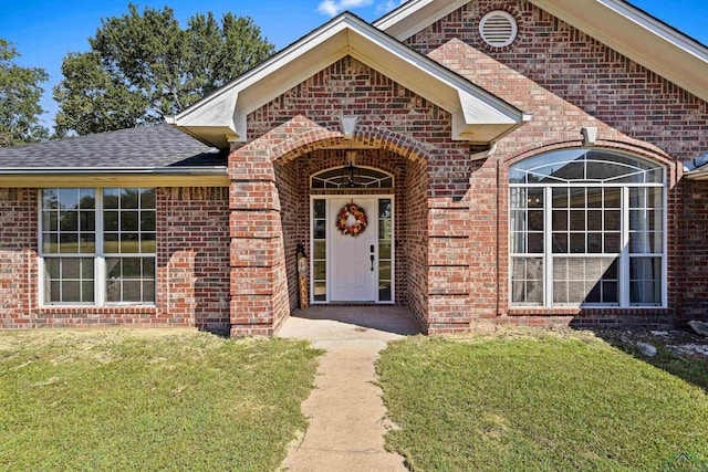 entrance to property featuring a yard