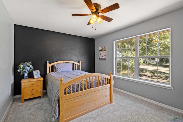 bedroom with ceiling fan and light carpet