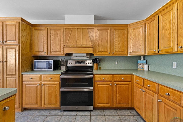 kitchen featuring appliances with stainless steel finishes, backsplash, and light tile patterned floors