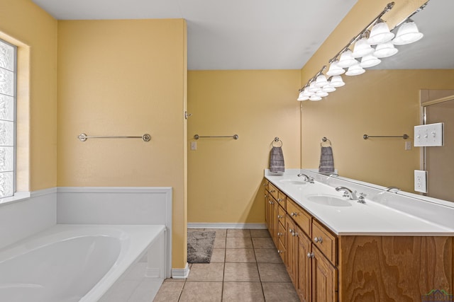 bathroom with tile patterned flooring, vanity, and a washtub