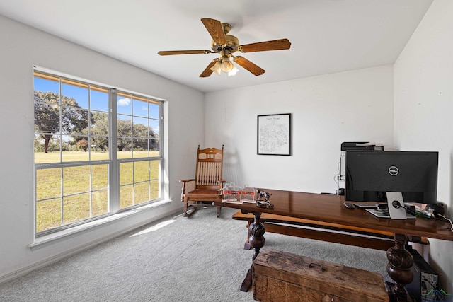 carpeted office space with ceiling fan