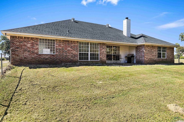 back of property featuring a yard and a patio area