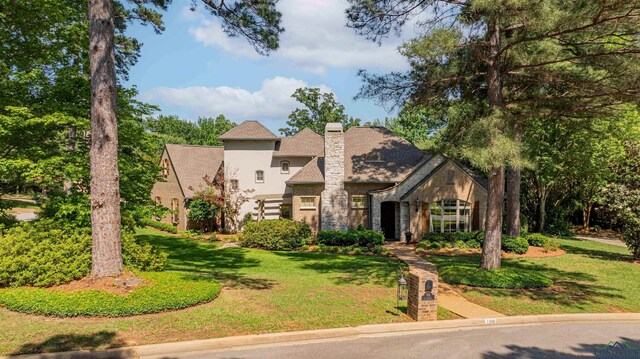 108 Fountainebleau Ave, Longview, TX 75605 - view of front of home featuring a front lawn, stone siding, stucco siding, and a chimney