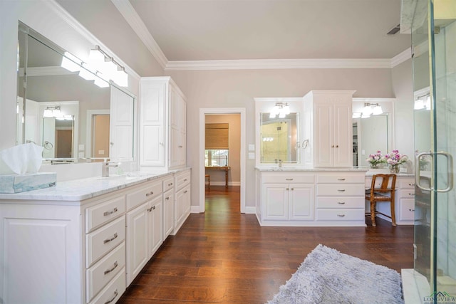 108 Fountainebleau Ave, Longview, TX 75605 - full bath featuring wood finished floors, ornamental molding, two vanities, a stall shower, and baseboards