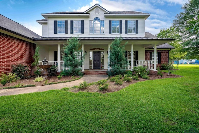 4300 Willow Bnd, Longview, TX 75602 - colonial-style house with a front yard, a porch, and brick siding