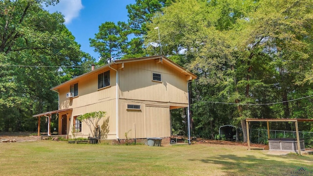 view of property exterior featuring a lawn and a jacuzzi