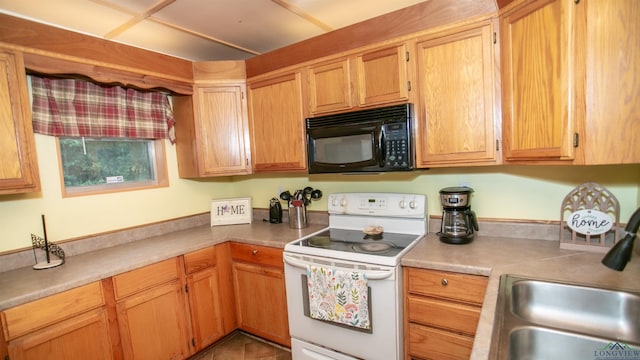 kitchen featuring sink, tile patterned floors, and white range with electric cooktop