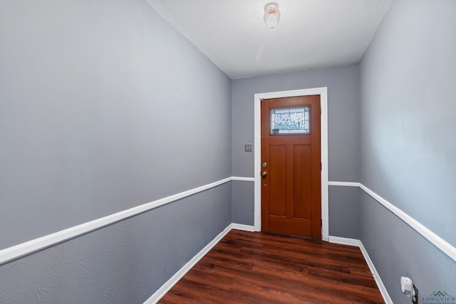 entryway featuring baseboards and wood finished floors