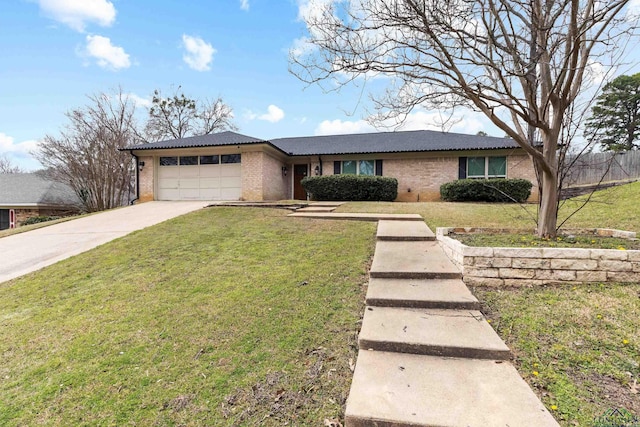 view of front of property featuring brick siding, a garage, and a front yard