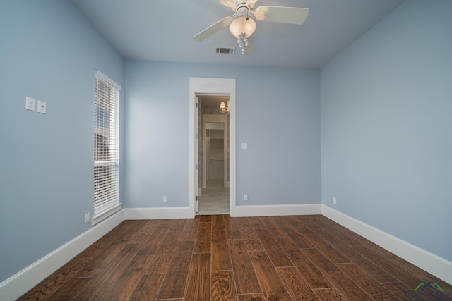 spare room with ceiling fan and dark wood-type flooring