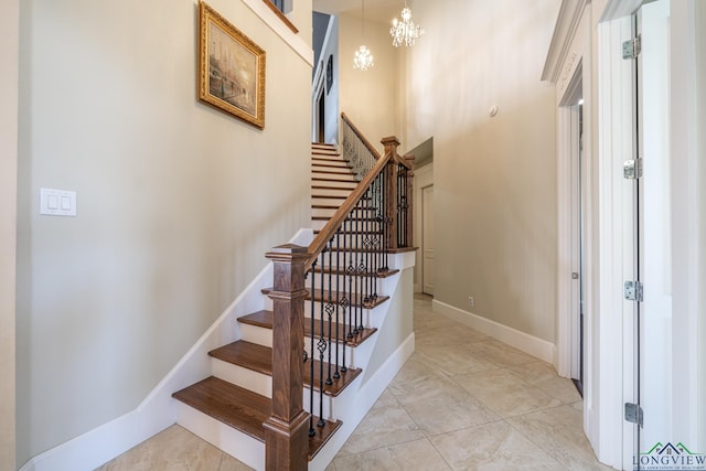 stairway featuring an inviting chandelier