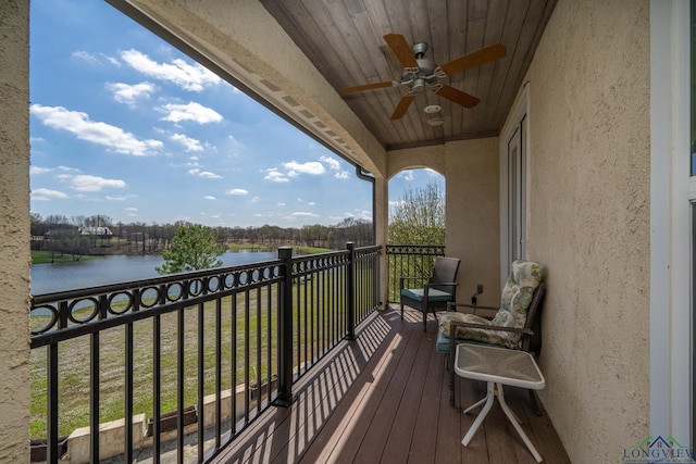 balcony with a water view and ceiling fan